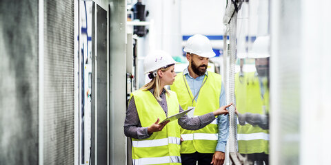 Frau und Mann in Technologiebereich im Gespräch